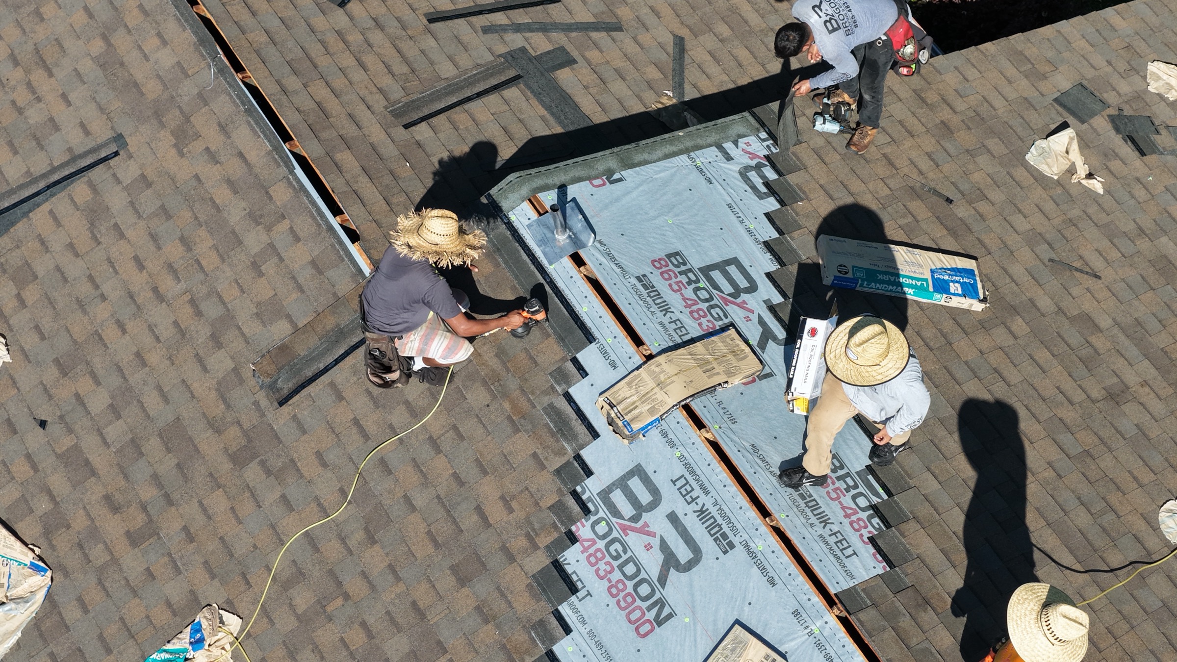 Brogdon roofers working on roof flashing and shingles